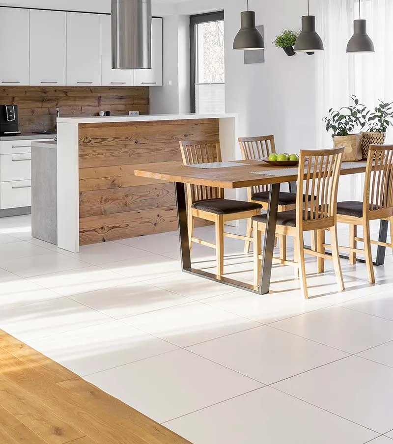 a kitchen with a wooden table and chairs