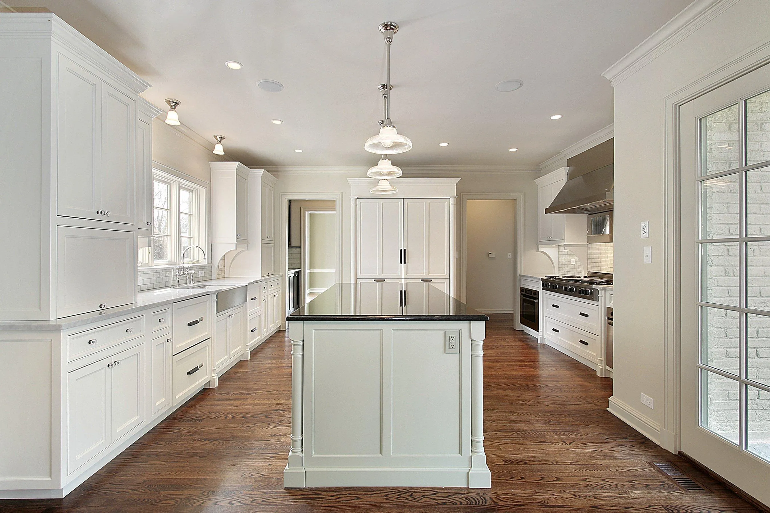 a large kitchen with a center island in the middle of the room