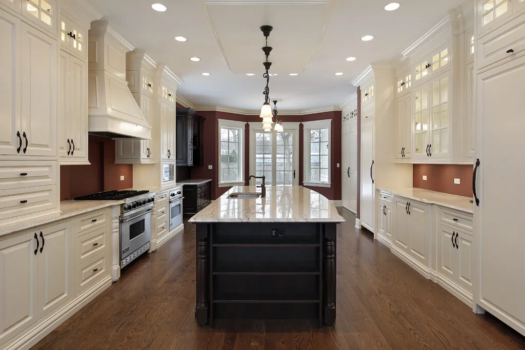a large kitchen with a center island in the middle of the room