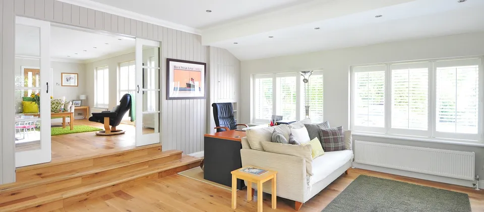 a living room filled with furniture and lots of windows