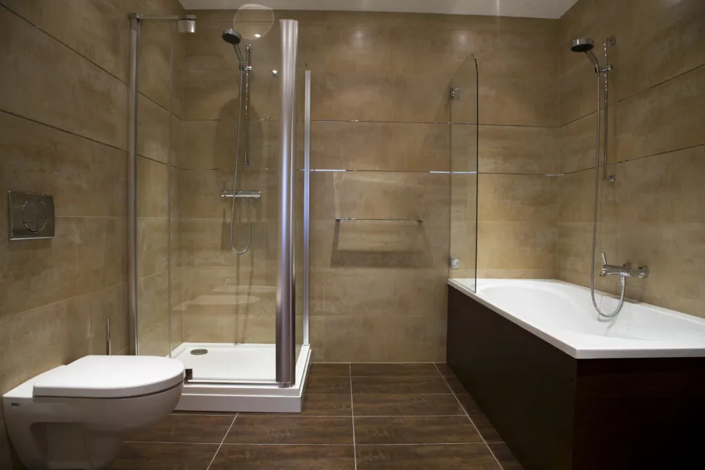 a bathroom with a toilet, shower, and bathtub
