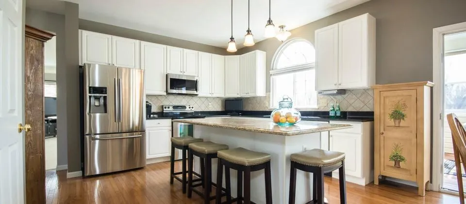 a kitchen with a center island with stools